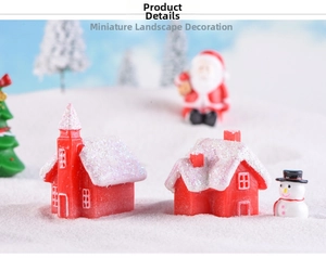 Detailed view of red resin Christmas candy house ornaments and snowman on artificial snow