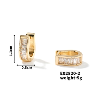 Detailed view of U-shaped gold earrings with zircon inlay, size 1.1cm by 0.8cm