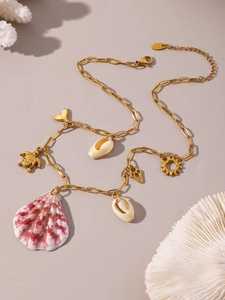 Close-up of golden ocean necklace with sea turtle, shell, and starfish charms