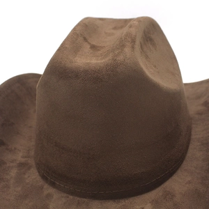 Close-up detail of brown suede cowboy hat showing textured fabric and stitching