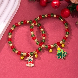 Detail of Christmas beaded bracelet with red green crystals, tree and bell charms