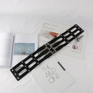 Detail of black multi-strap punk waist belt with silver buckles on fashion magazines