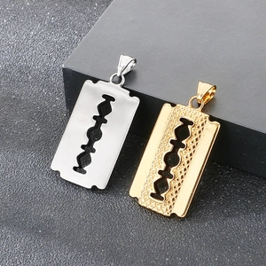 Macro detail of silver and gold razor blade pendants with textured diamond patterns
