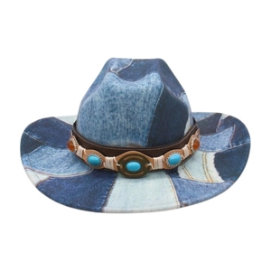 Detail of blue denim patchwork cowboy hat with brown leather band and stone accents
