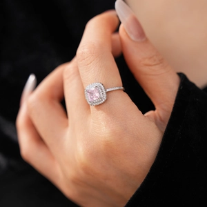 Detail of pink princess cut zircon crown ring worn on hand with pavé setting