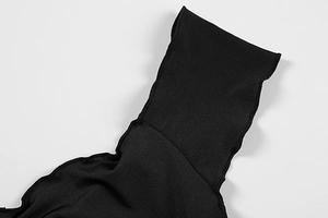 Macro shot of black knitted tank top strap featuring precise overlock stitching detail