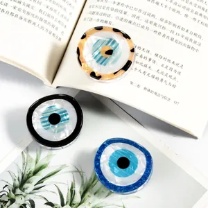 Three elegant evil eye pattern resin hair clips in black, blue and tortoiseshell finishes