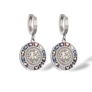 Close-up of bohemian silver steel earrings with evil eye motif and colorful enamel icons