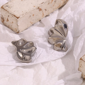 Minimalist silver geometric petal stud earrings in stainless steel on white stone base
