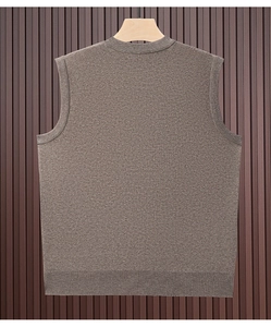 Detailed view of brown knit texture on a men's casual sleeveless vest sweater on a hanger