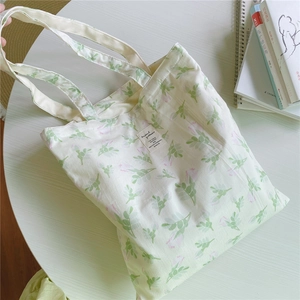 Close-up of floral cotton canvas tote bag with green leaves and pink flower prints