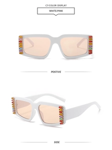Detail of square white sunglasses with pink lenses and colorful rhinestone side accents