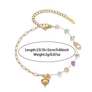 Detail view of gold stainless steel bracelet featuring natural crushed gemstones and heart charm