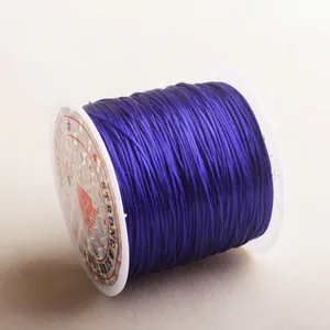 Detail of strong stretchy flat elastic bead cord on white spool for jewelry making