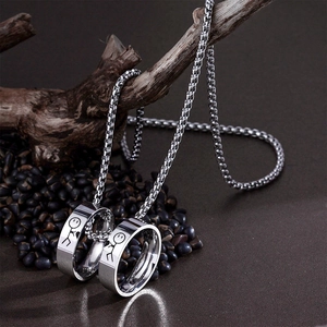 Matching stainless steel stickman heart rings pendant necklace on a natural wood branch