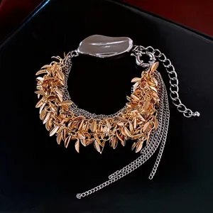 Multi-layer leaf tassel bracelet in mixed gold and silver tones with adjustable clasp