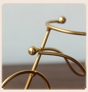 Macro detail of golden metal tricycle craft with welded texture and matte gold finish
