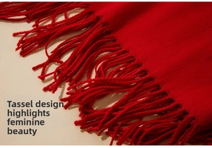 Macro shot of red pashmina scarf showcasing the delicate fringe and soft wool texture