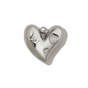 Detail of silver heart-shaped stainless steel pendant set with three clear crystals