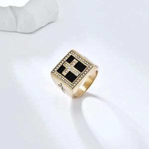 Macro detail of gold square hip hop ring with black cross inlay and sparkling zircon stones