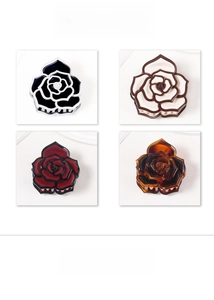Detailed view of 3D camellia flower hair claws in four elegant color combinations