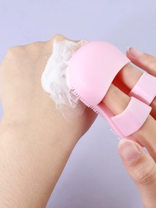 Pink silicone finger cleansing brush with soft bristles for pore and makeup removal