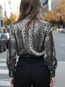 Back view of a satin leopard print long sleeve shirt showing smooth silk texture