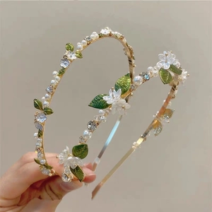 Elegant gold headband with white flowers, green leaves, pearls and crystals