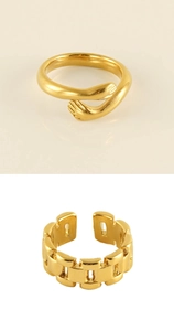 Detailed view of two gold adjustable rings featuring hug hands and chunky chain designs