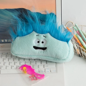 Close-up of mint green plush stationery bag with funny cartoon face and hair styling kit