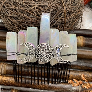 Macro detail of Bohemian moon crystal hair comb with iridescent stones and moon emblem