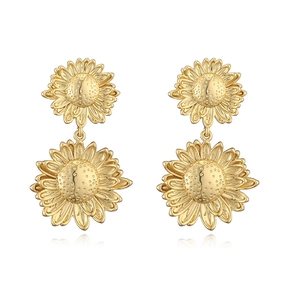 Detailed view of vintage gold sunflower drop earrings featuring layered petals and texture