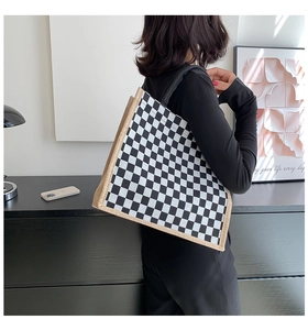 Detail of checkered linen tote bag showing side view with reinforced stitching on the edge
