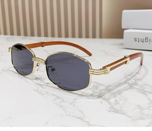 Nahaufnahme der goldenen Metallsonnenbrille mit dunkelbraunen Bügeln in Holzoptik