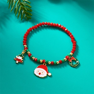 Detailed shot of Christmas beaded bracelet with Santa and tree charms on blue background