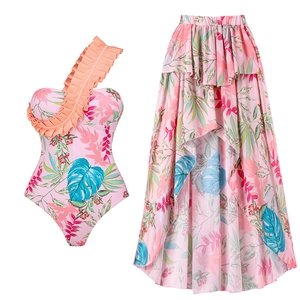 Detail of floral one-shoulder swimsuit with ruffles and matching irregular hem skirt