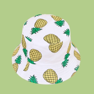 Close-up of high-quality cotton bucket hat with vibrant yellow pineapple print pattern