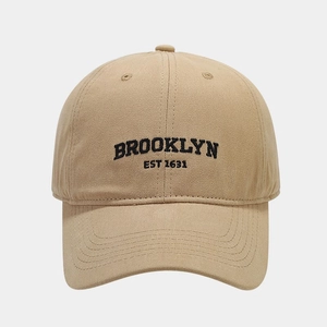 Detail of Brooklyn embroidery on khaki cotton canvas baseball cap with dense stitching