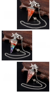 Detailed view of hexagonal resin pendulum pendants with colorful crystals and moon charms