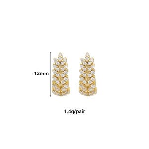 Detail view of 12mm gold wheat ear earrings with white cubic zirconia inlay