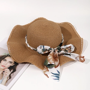 Elegant wide brim straw hat with floral ribbon bow and pearl chain for summer sun protection