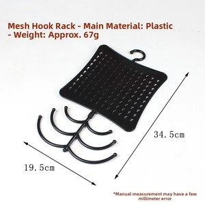 Detail of black plastic jewelry organizer rack with grid mesh and hooks for earrings