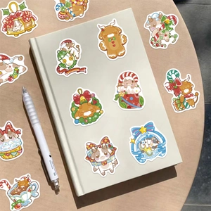Holographic Christmas cartoon cow stickers on a laptop and wooden desk, 50-piece set