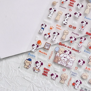 Detailed view of cartoon dog stickers and letter designs on textured paper