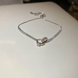Detail showing silver knotted heart bracelet with zircon stones and adjustable slider