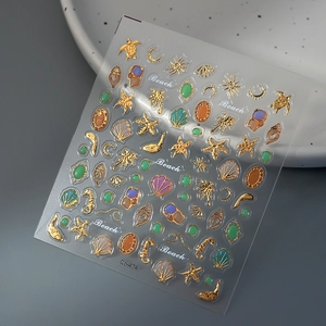 3D gold relief ocean nail stickers with sea turtles and shells on a decorative tray