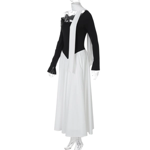 Detail of elegant black long sleeve bodice with contrasting white flowing skirt and scarf