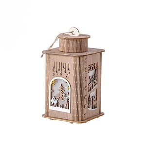 Wooden Christmas lantern with reindeer and tree cutouts glowing with warm light