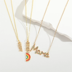 Golden necklaces with HAPPY, BABY, and Mama pendants with colorful gems and rainbow