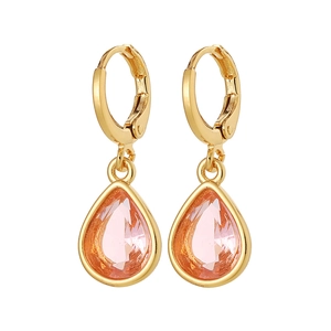 Close-up of pink teardrop crystal earrings with polished gold-plated huggie hoops